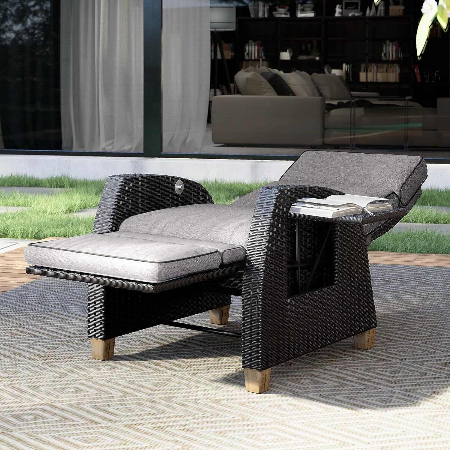 Outdoor reclining wicker lounge chair with cushion and flip-up side table on patio