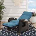 Outdoor reclining wicker lounge chair with cushion and flip-up side table on patio